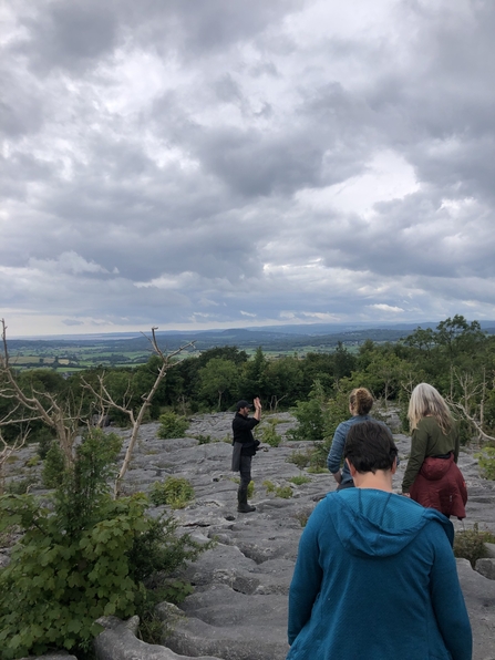 Group of Cumbria Wildlife Trust staff exploring the limestone pavement habitat of Hutton Roof.